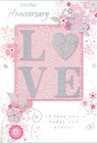 The card in the image offers a soft celebration of enduring romance, its pastel colours and refined details evoking the gentle character of Somers Town's hidden gardens and quiet corners. At the very centre, the word LOVE stands out in raised, glitter-soft lettering, each stroke edged with a fine shimmer. The O is replaced by a textured silver heart, densely sparkling and slightly embossed, as if carefully crafted to be both seen and felt. Around this focal point, delicate blossoms in blush pink and muted mauve open like miniature watercolour roses and anemones, their petals softly shaded and outlined with thin, graceful lines. These flowers float on slender stems and swirling vines that trail across the card, creating an impression of movement and care, similar to the flowing shapes of a carefully tied anniversary bouquet. Scattered among them are tiny flourishes-curved tendrils, loose petals, and subtle butterfly motifs-that add a sense of playfulness and lightness. The background is a gentle blend of pastel pink and silvery grey tones, giving the composition a quiet intimacy, as though the scene were lit by late-afternoon light over Somers Town's rooftops. In elegant script, the words On Our Anniversary and I love you today and always are written with a modest grace, nestling harmoniously among the floral artwork. The result feels like a paper echo of a spring garden, perfectly suited to accompany anniversary flowers delivered across Somers Town-from flats tucked near St Pancras to homes around the local squares-whispering love in a soft yet profoundly heartfelt way.